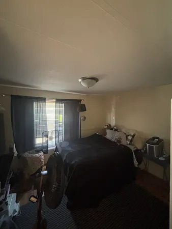 a bedroom with a bed and window