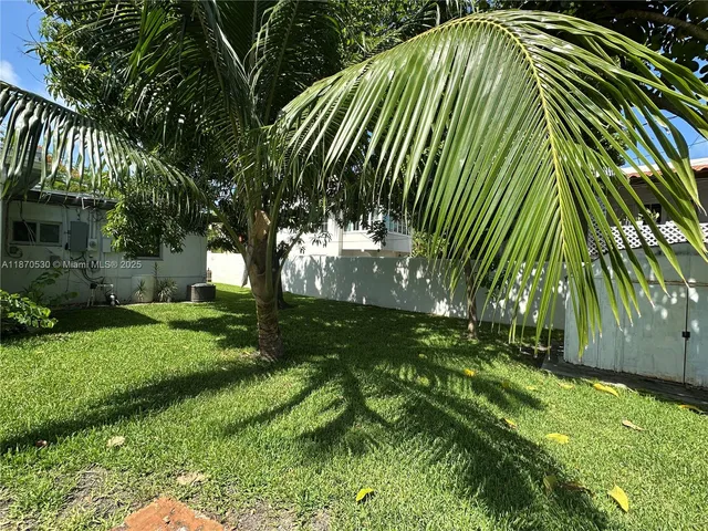 a view of backyard with swimming pool and outdoor seating