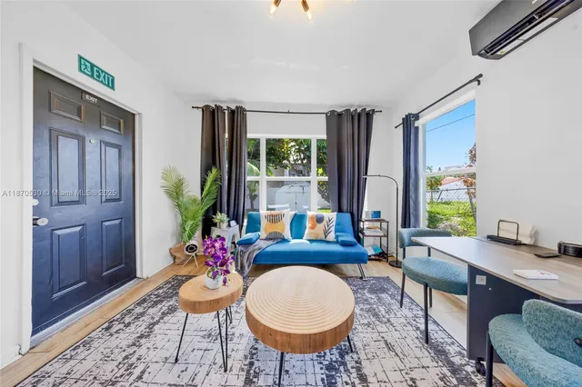 a living room with furniture a window and a potted plant