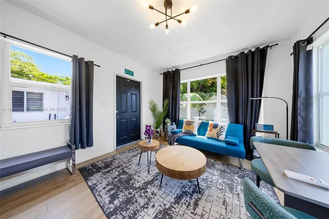 a living room with furniture a rug and a large window