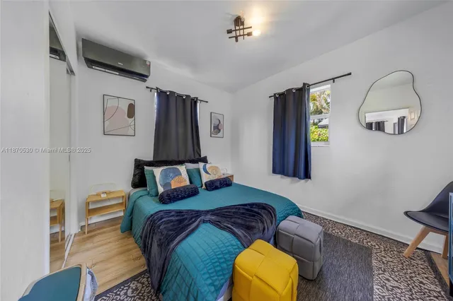 a bedroom with bed and a window