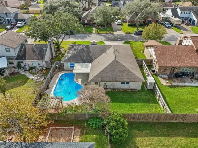 an aerial view of a house with a swimming pool outdoor seating and yard