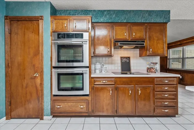 a kitchen with stainless steel appliances granite countertop a stove and a microwave