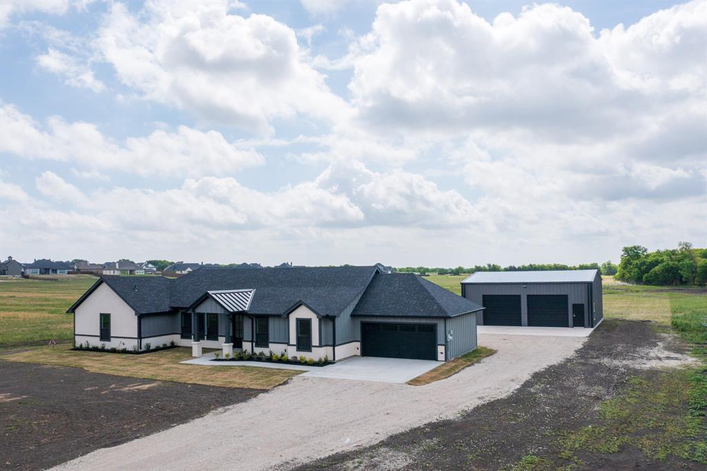 The property features a ranch-style home with a dark roof and a combination of light and dark exterior siding