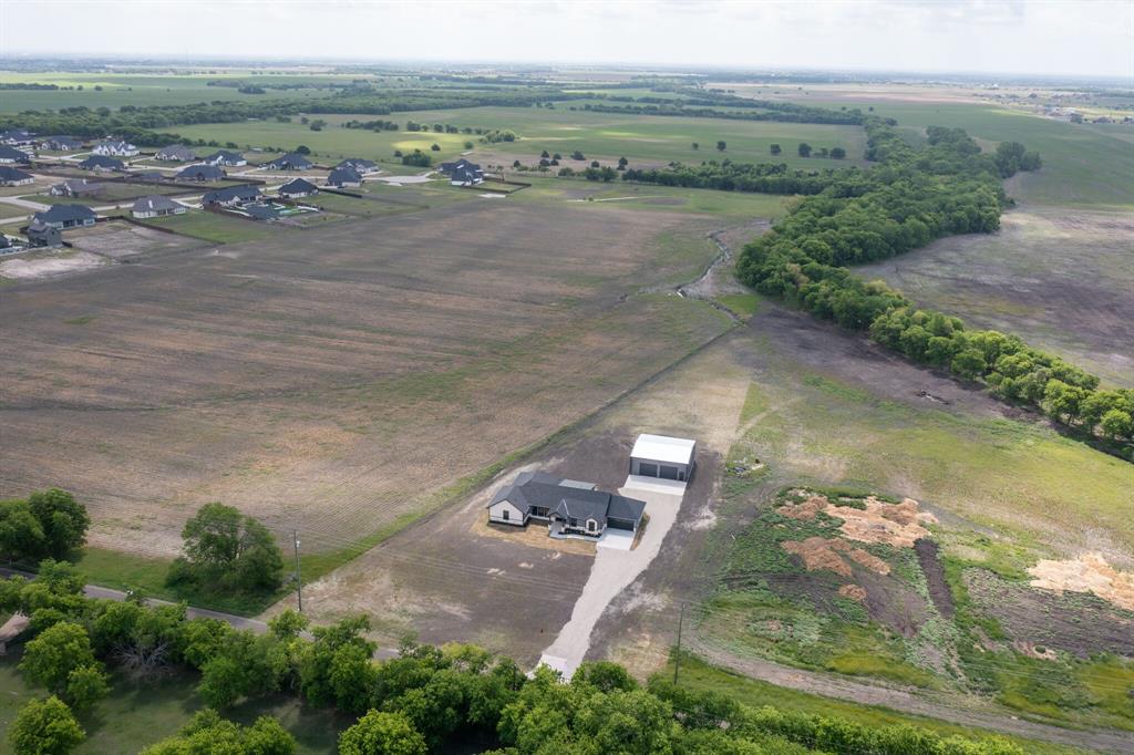 901 Old Maypearl Road Waxahachie, TX 75167 - Photo 17 of 17 Aerial view of the property, showcasing a single-story home with an expansive surrounding landscape