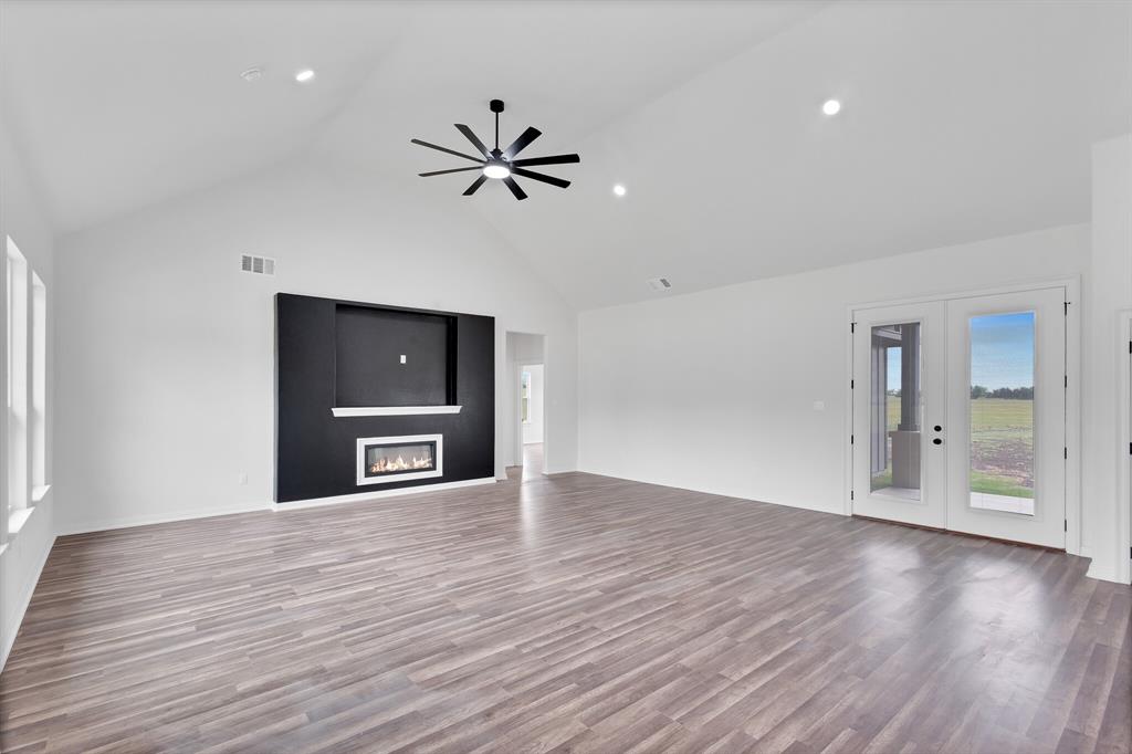 901 Old Maypearl Road Waxahachie, TX 75167 - Photo 7 of 17 Spacious living area featuring a vaulted ceiling, recessed lighting, and a contemporary fireplace with a media niche