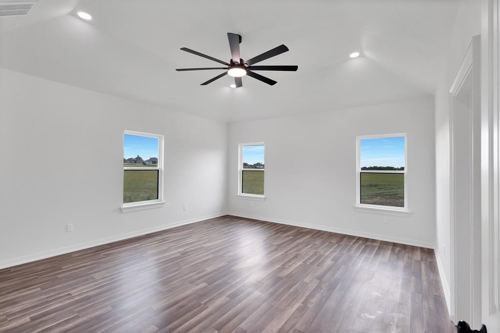 901 Old Maypearl Road Waxahachie, TX 75167 - Photo 10 of 17 The room features vaulted ceilings, recessed lighting, and a modern ceiling fan