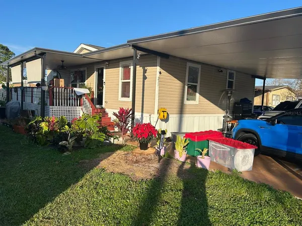 a view of a house with yard and sitting area