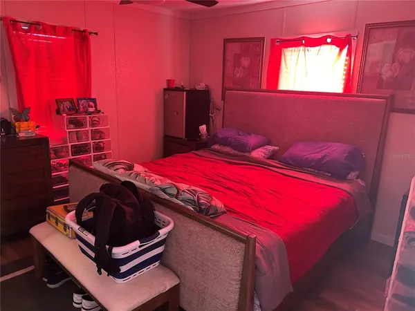 a bed sitting in a bedroom next to a window