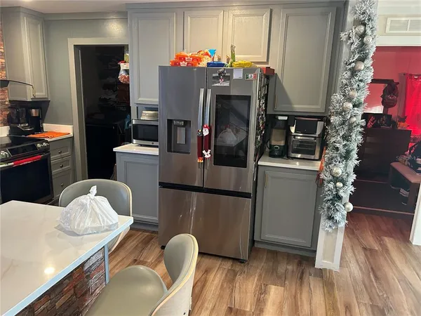 a kitchen with stainless steel appliances granite countertop a refrigerator a microwave oven a sink and dishwasher