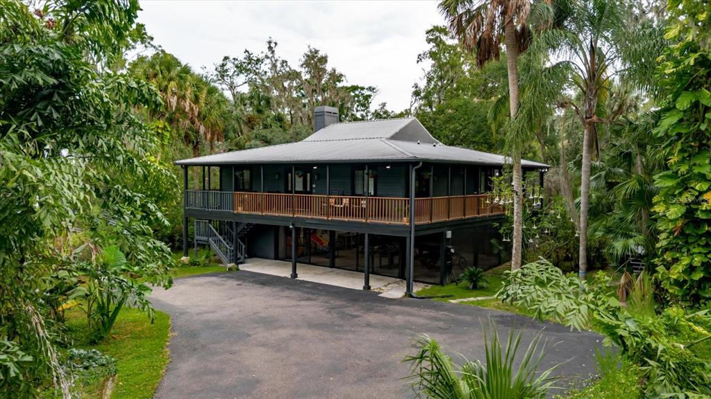 a view of a house with a yard and balcony