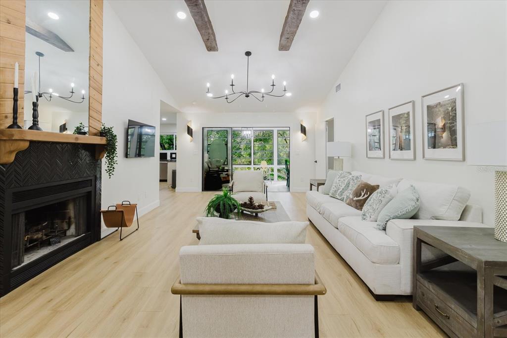 8304 Revels Road Riverview, FL 33569 - Photo 11 of 99 a living room with furniture a fireplace and a chandelier