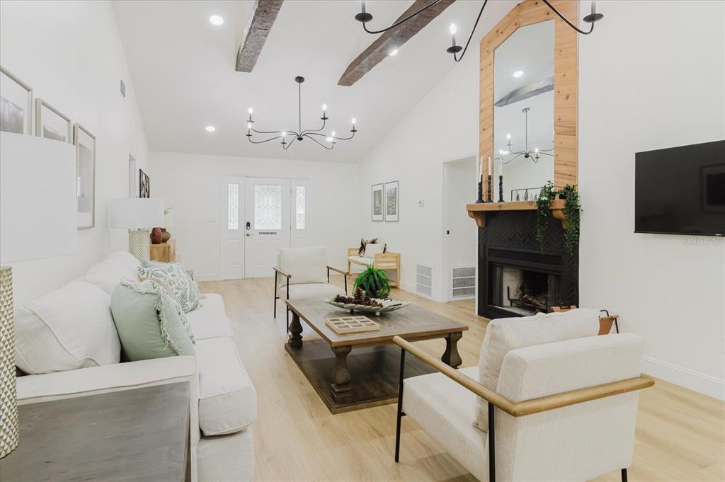 8304 Revels Road Riverview, FL 33569 - Photo 14 of 99 a living room with furniture a fireplace and a flat screen tv