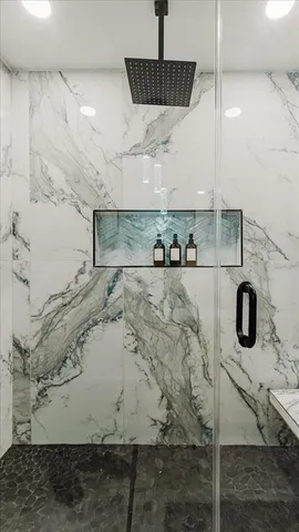 a bathroom with a toilet sink a mirror and shower