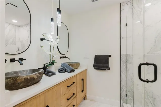 a bedroom with a bed and a ceiling fan