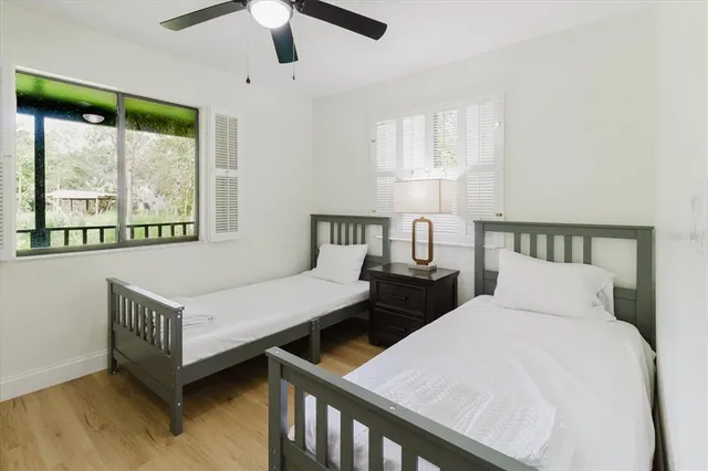 a bedroom with a bed and a ceiling fan