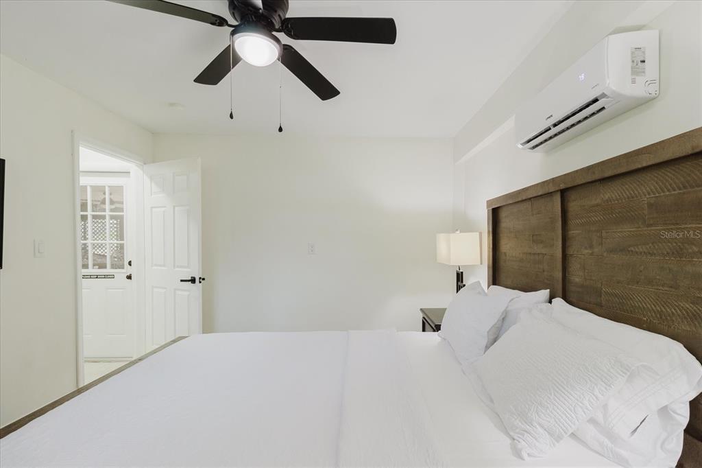 8304 Revels Road Riverview, FL 33569 - Photo 52 of 99 a bedroom with a large bed and a chandelier fan
