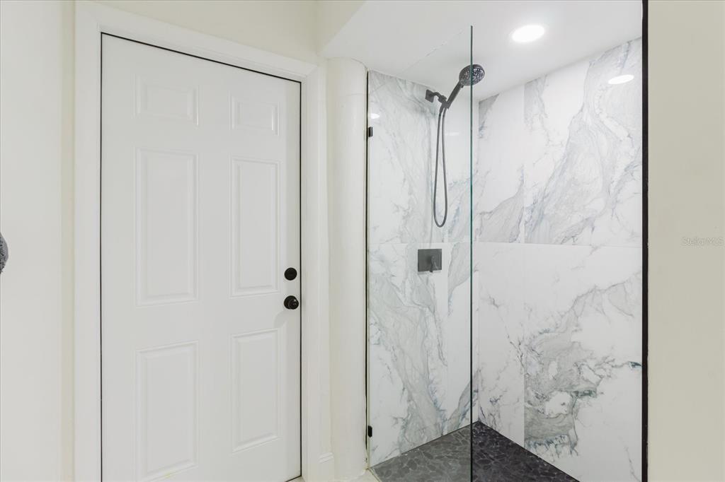 8304 Revels Road Riverview, FL 33569 - Photo 54 of 99 a bathroom with a shower and a glass door