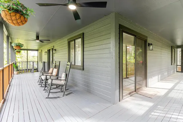a living room with furniture a fireplace and a chandelier
