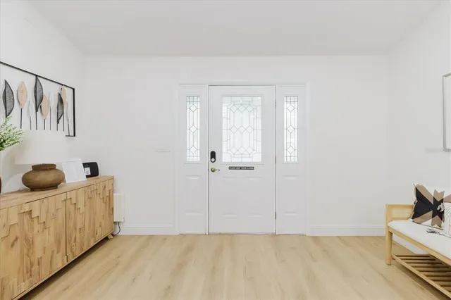 a living room with furniture a fireplace and a chandelier