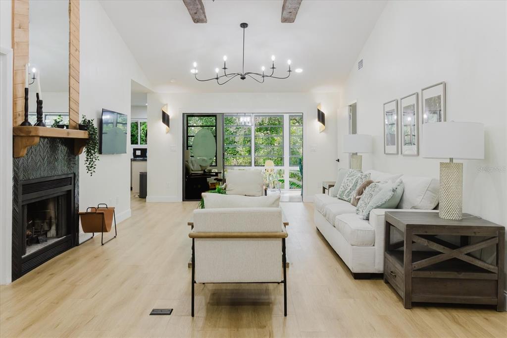 8304 Revels Road Riverview, FL 33569 - Photo 90 of 99 a living room with furniture a fireplace and a chandelier