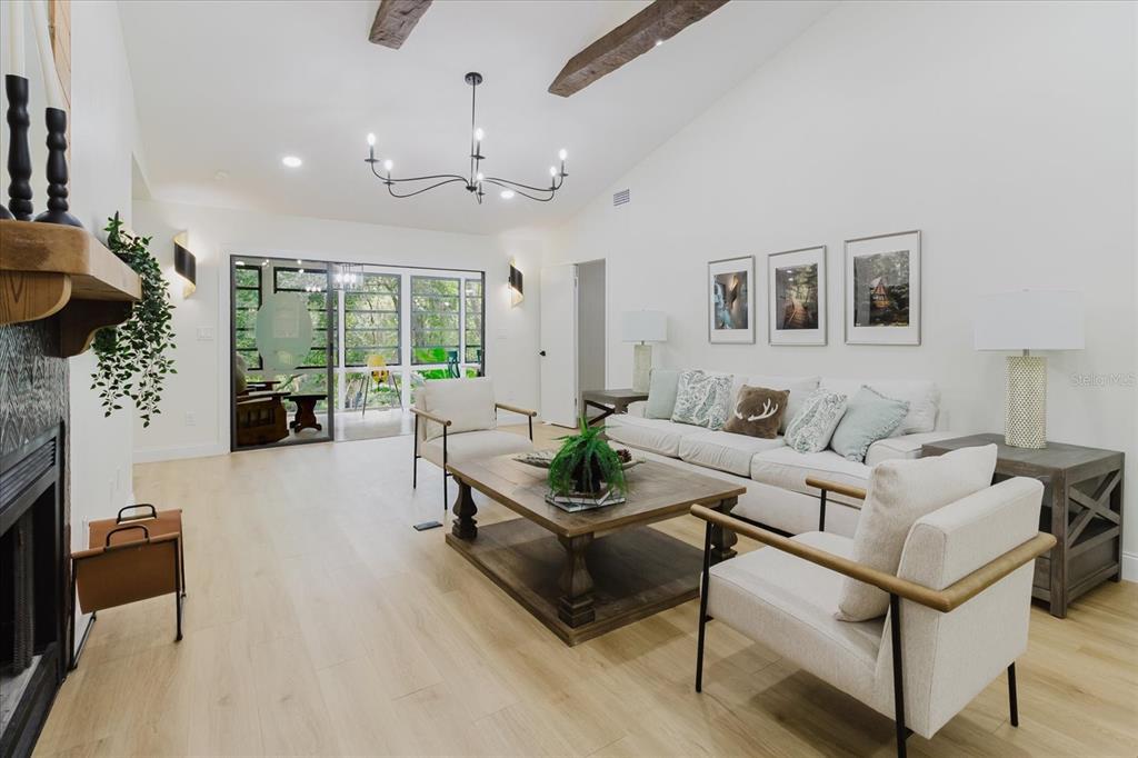 8304 Revels Road Riverview, FL 33569 - Photo 92 of 99 a living room with furniture and a chandelier