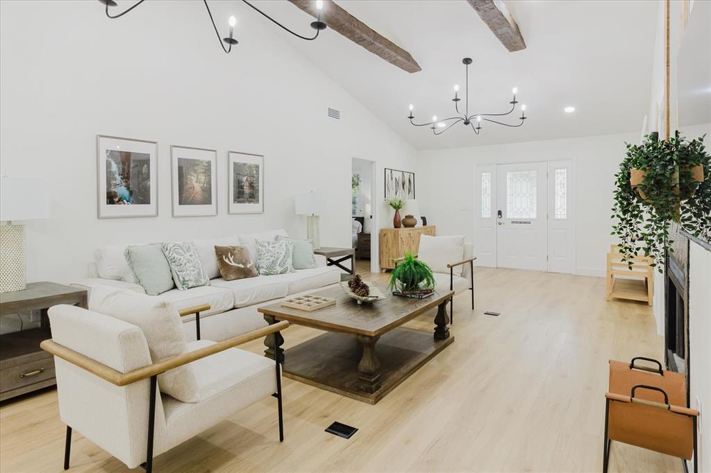 8304 Revels Road Riverview, FL 33569 - Photo 95 of 99 a living room with furniture and a chandelier