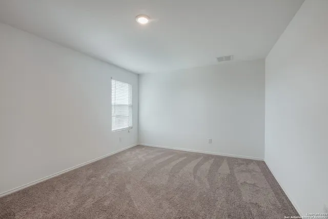 an empty room with a empty space and window