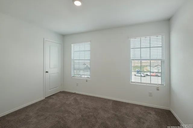 a view of a backyard with table and chairs and wooden fence