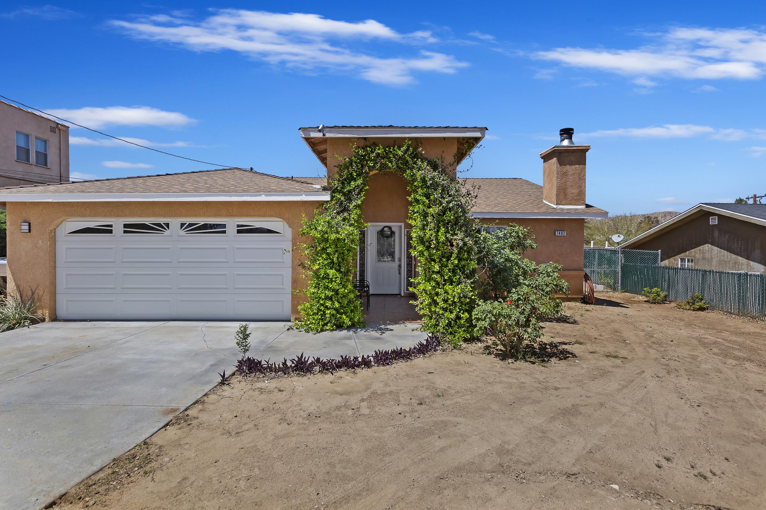 front view of a house with potted plants