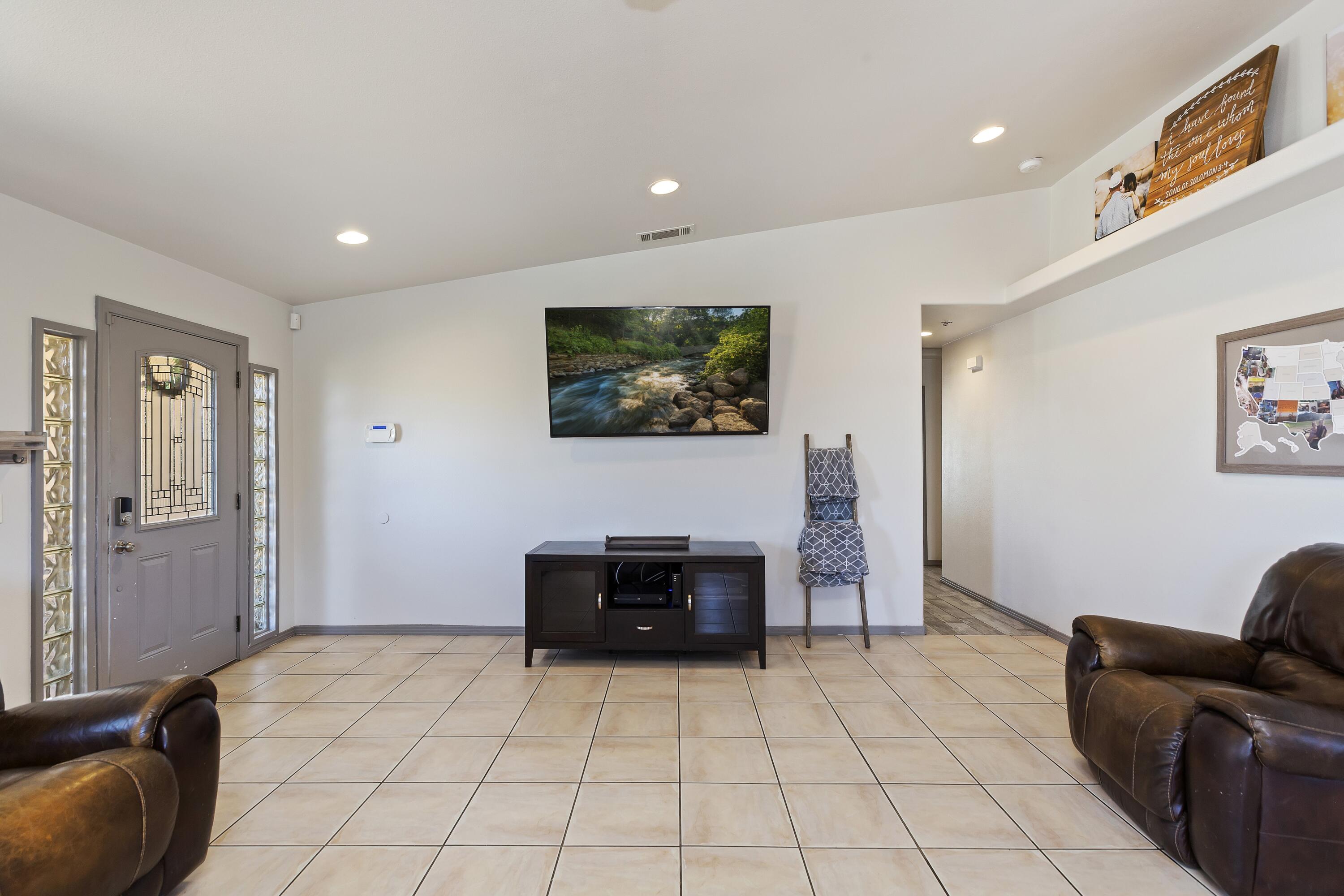 7482 Apache Trail Yucca Valley, CA 92284 - Photo 11 of 38 a living room with furniture and a flat screen tv