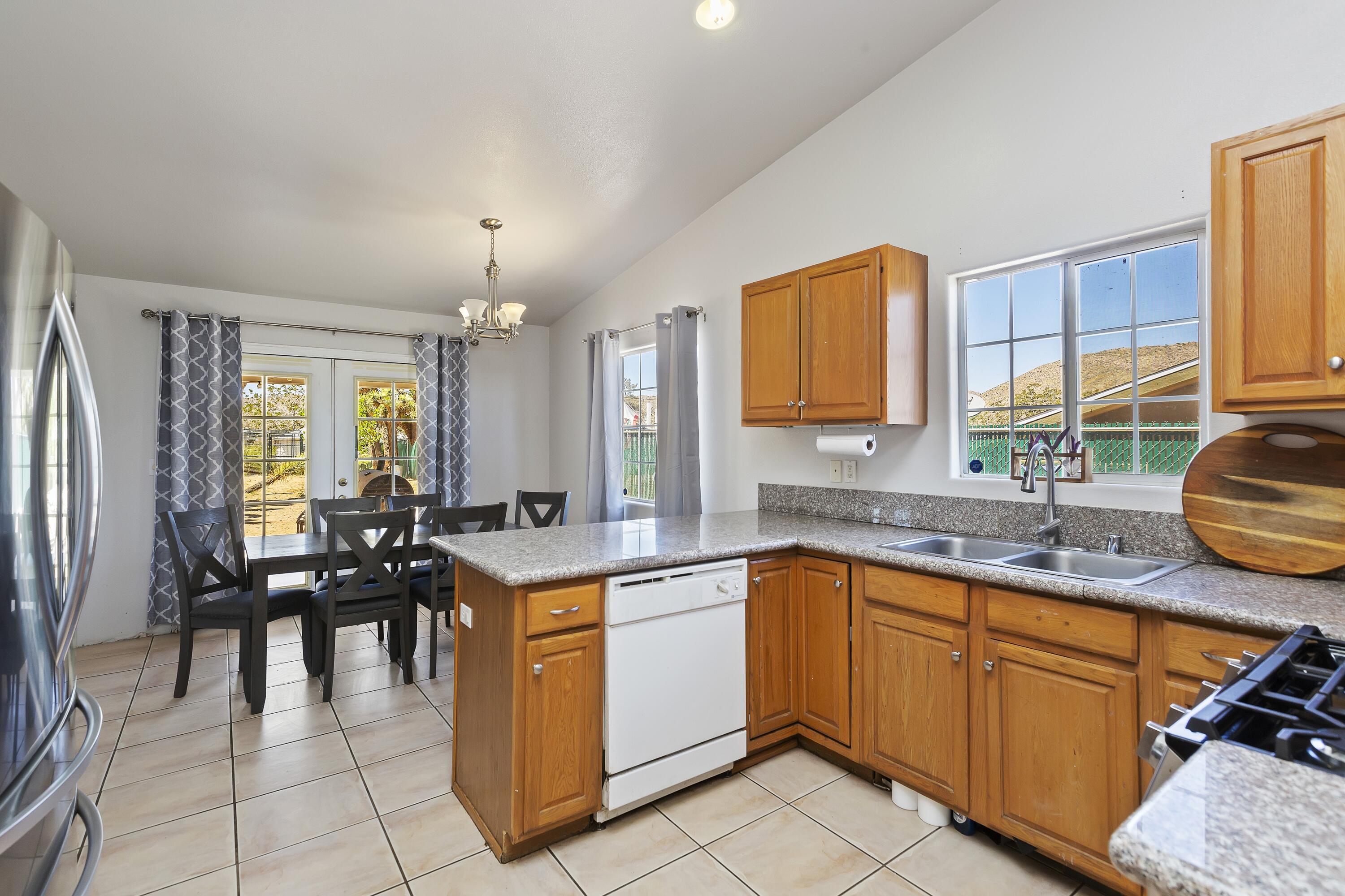 7482 Apache Trail Yucca Valley, CA 92284 - Photo 16 of 38 a kitchen with a sink stove and cabinets