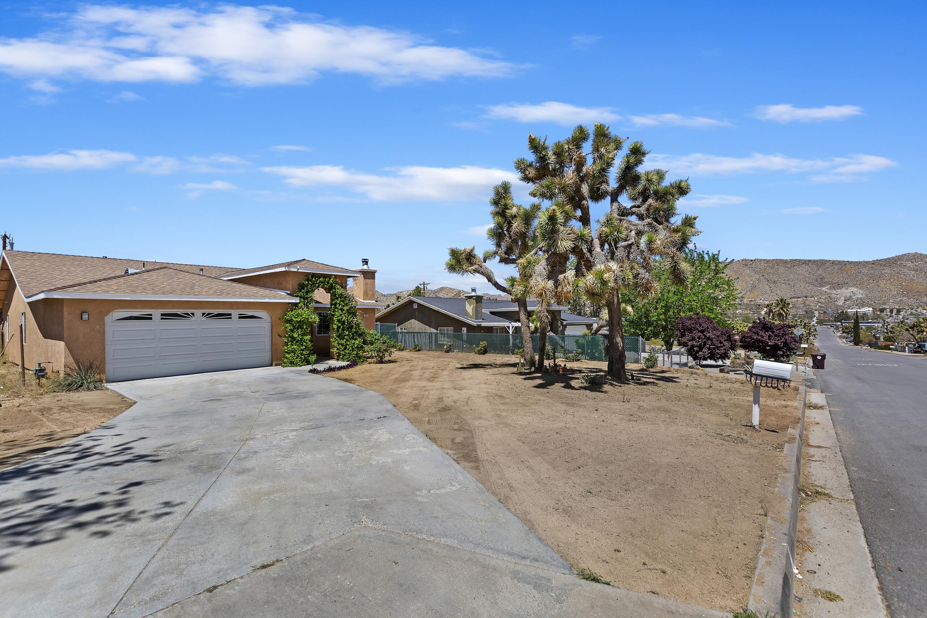 7482 Apache Trail Yucca Valley, CA 92284 - Photo 2 of 38 a view of a street with a building in the background
