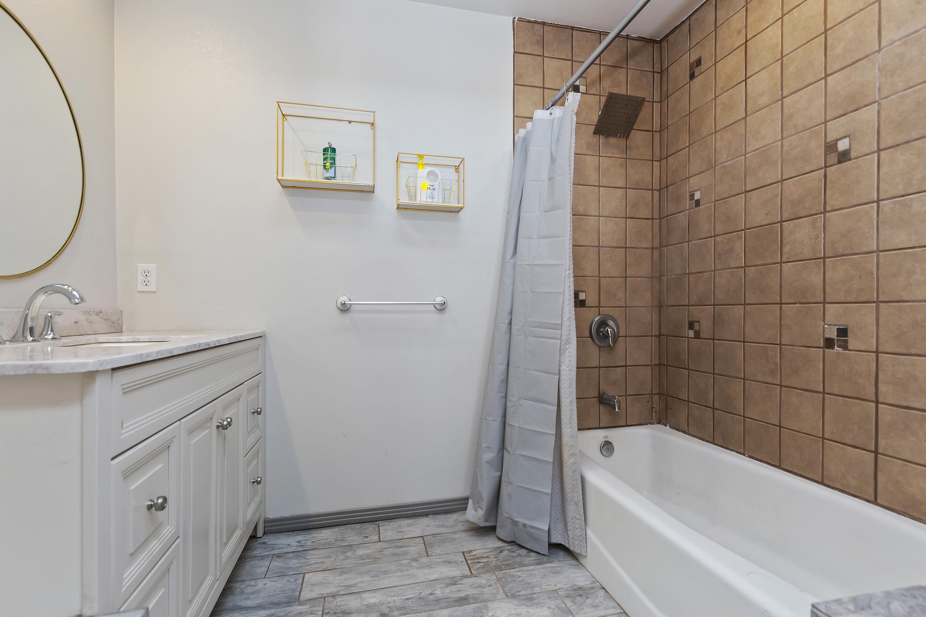 7482 Apache Trail Yucca Valley, CA 92284 - Photo 29 of 38 a bathroom with a tub a sink and a shower