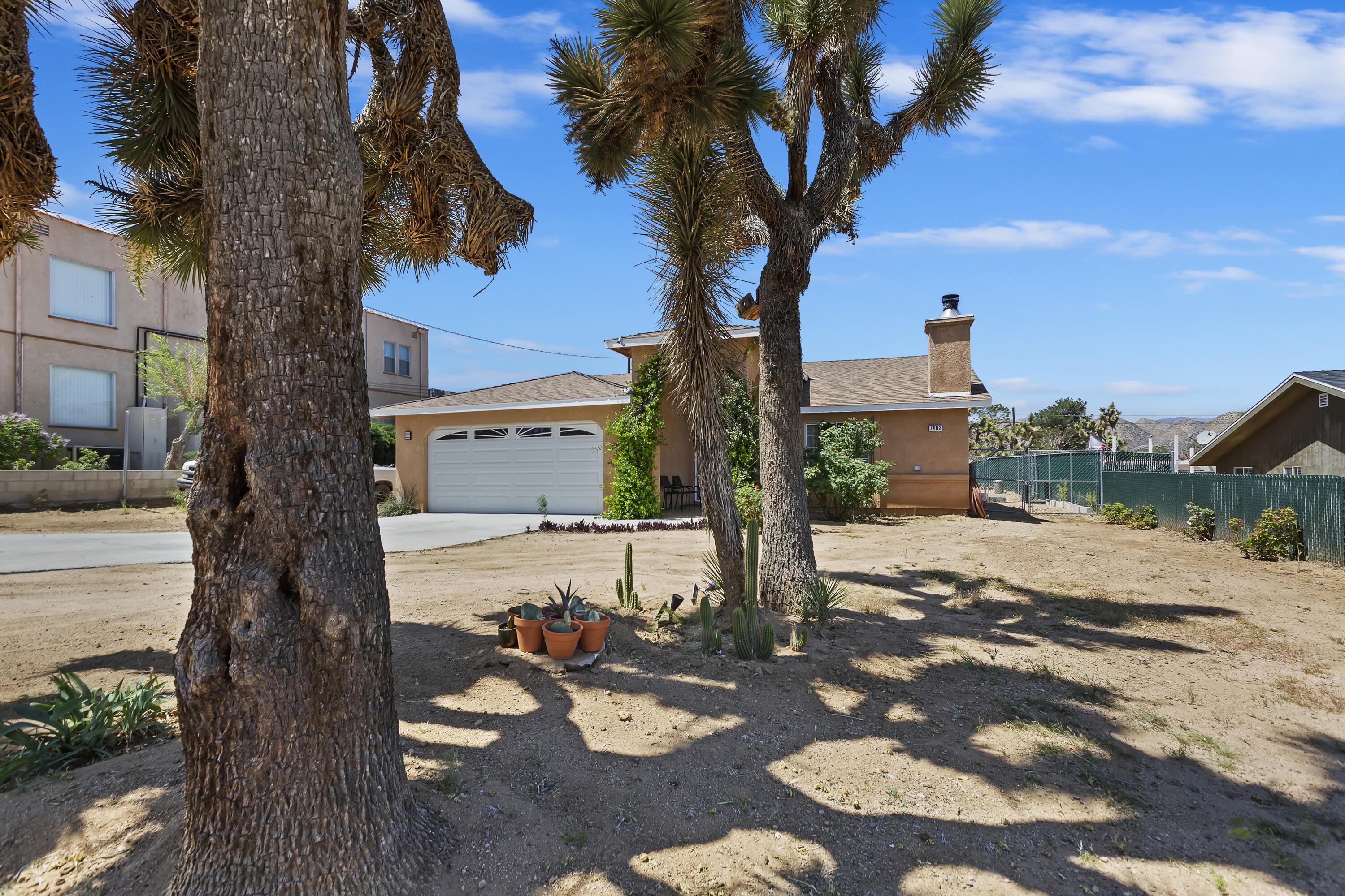 7482 Apache Trail Yucca Valley, CA 92284 - Photo 5 of 38 a view of a street with a tree