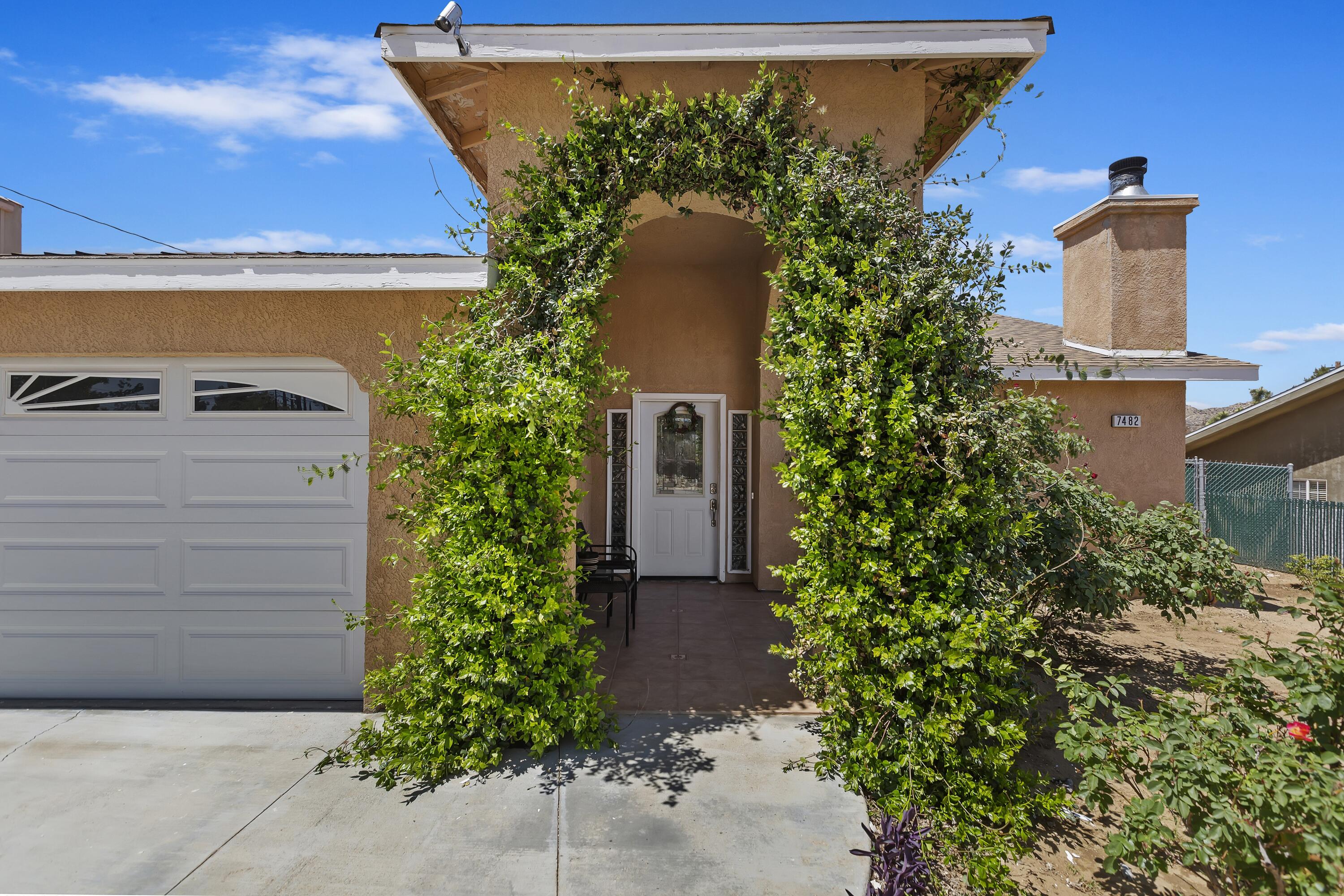 7482 Apache Trail Yucca Valley, CA 92284 - Photo 6 of 38 a house view with a garden space