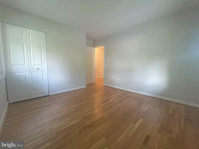 a view of an empty room and wooden floor