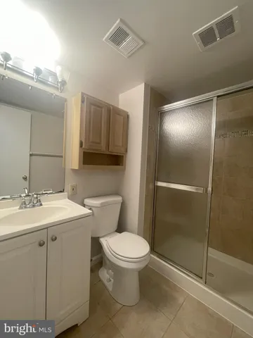 a bathroom with a toilet sink and shower