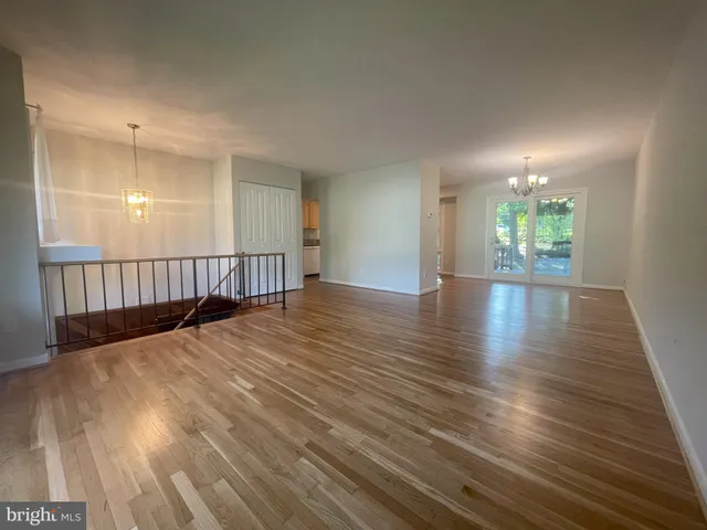 a view of a room with wooden floor