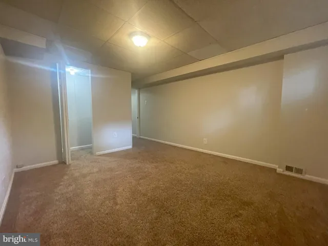 an empty room with a empty space and windows