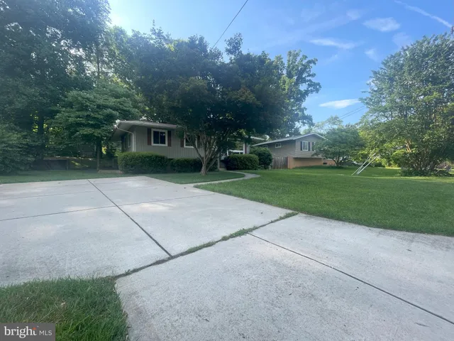 a view of backyard with deck and trees