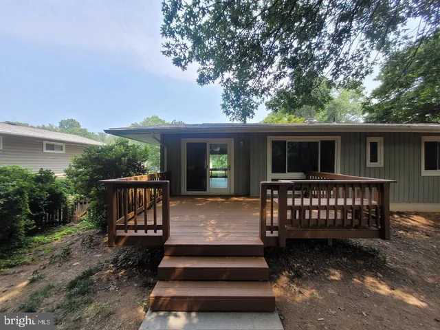 a view of a backyard with a deck and a garden