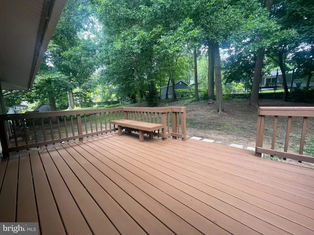a view of backyard with a deck and wooden floor