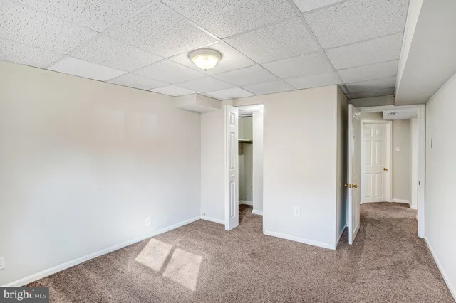 a view of a livingroom with an empty space and hallway