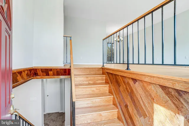 a view of a room with wooden floor and stairs