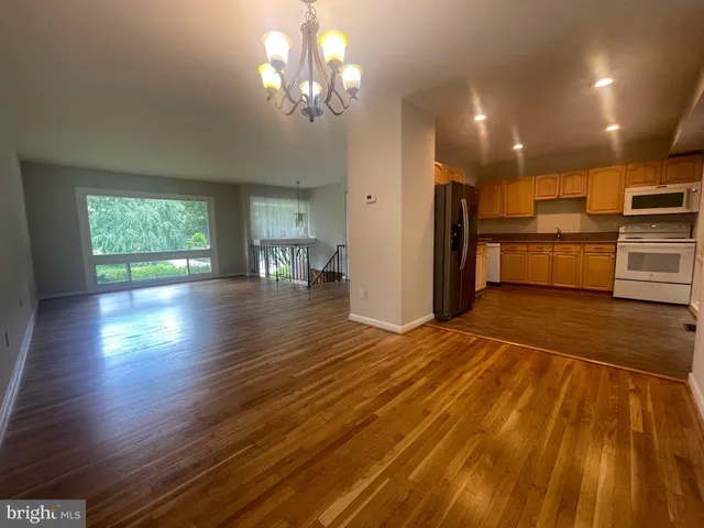 a view of a kitchen with a sink and refrigerator