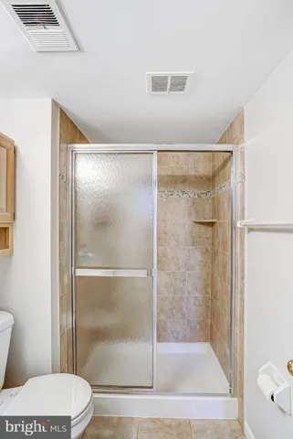 a bathroom with a glass shower door