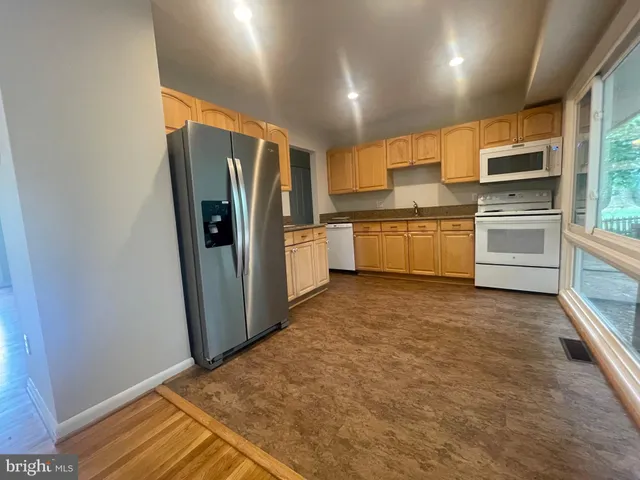 a kitchen with stainless steel appliances a refrigerator and a stove top oven
