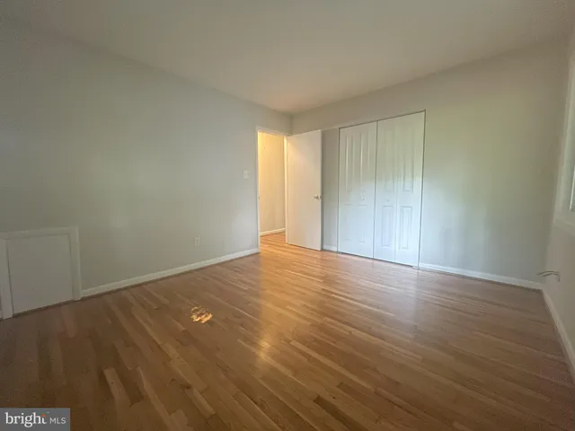 a view of an empty room and wooden floor