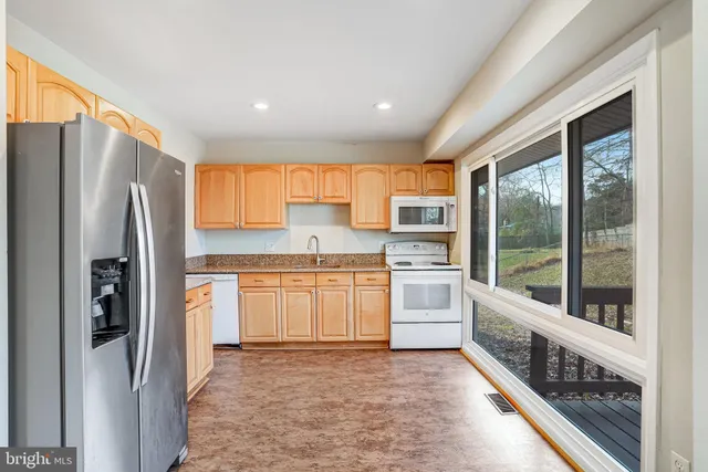 a kitchen with stainless steel appliances a refrigerator sink and cabinets